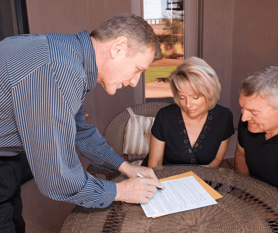 three people signing final preparations paperwork