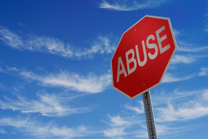 stop sign with the words abuse on it with the blue sky in the background