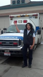 Paramedic Waving standing next to an ambulance