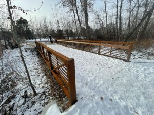 Copper colored bridge with snow and ice