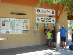People standing in line at a window to get tickets for the Boise River Raft and Tube