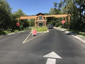 Entrance to Park with stop signs and wooden pergola over the road