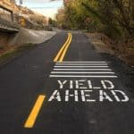 Black top road with Yield Ahead markings