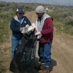 volunteers putting trash into bag
