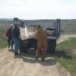 loading discarded fence into trailer