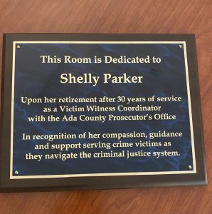 A plaque reads that a victim room is dedicated in Shelly Parker's honor