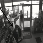 female walking into a store behind a male with an arrow pointing to him