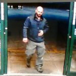 bald male in black jacket in doorway