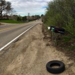 empty tire near mailboxes on the side of the road