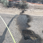 Asphalt scorching leading to the side of the road that is smoldering