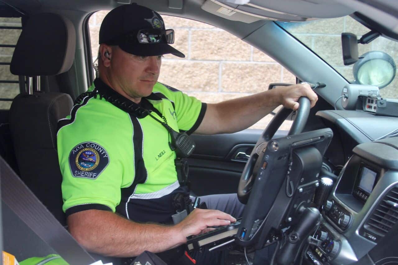 Sheriff sitting in Patrol Car working on his computer