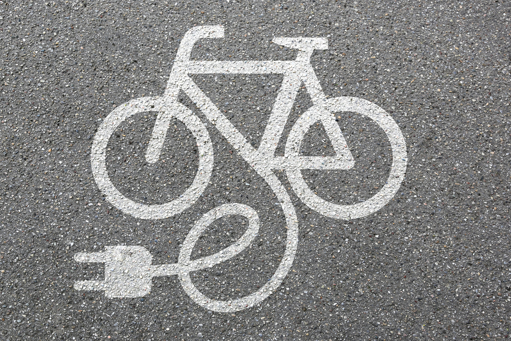 electric bike plug in emblem spray painted on asphalt